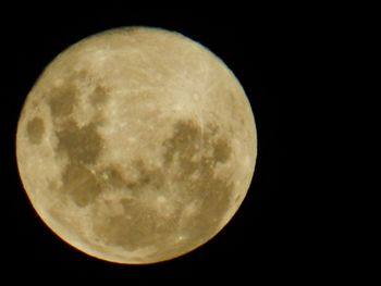 Low angle view of moon against dark sky