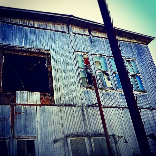 building exterior, architecture, built structure, low angle view, window, building, residential building, residential structure, blue, house, clear sky, day, outdoors, sky, old, balcony, no people, brick wall, exterior, wall - building feature