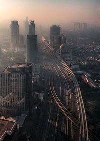 High angle view of buildings in city against sky during sunset