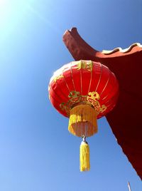 Low angle view of lantern against blue sky