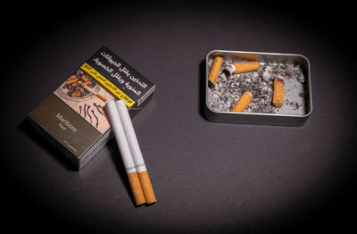 High angle view of cigarette against black background