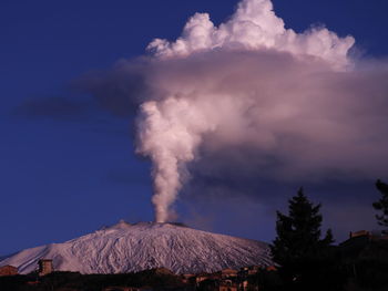 Smoke emitting from volcanic mountain against sky