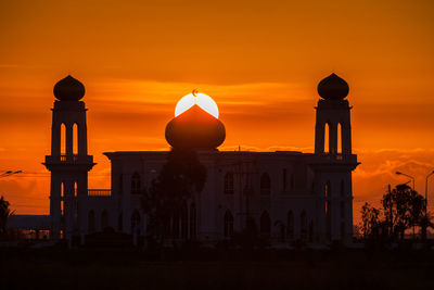 Silhouette building against sky during sunset