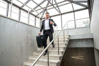 Businessman walking on staircase