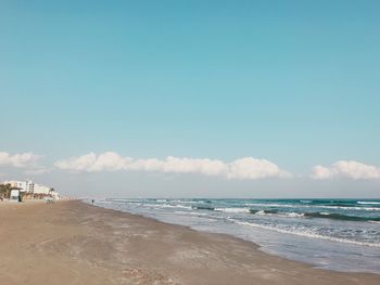 Scenic view of beach against blue sky