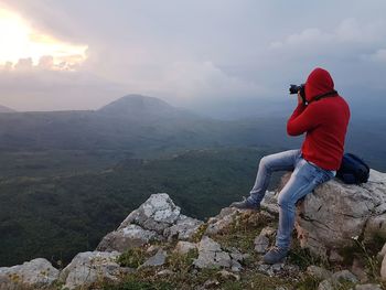 Full length of man on rock against sky
