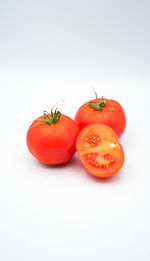 Close-up of tomatoes against white background