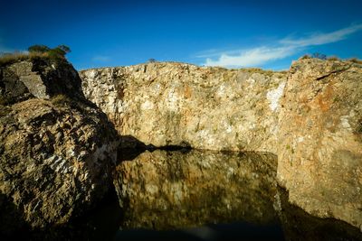 Low angle view of rock formation against blue sky
