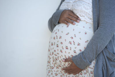 Midsection of woman wearing sweater