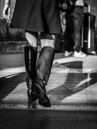 Low section of woman walking on street