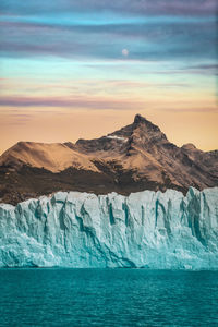 Scenic view of sea against mountain range