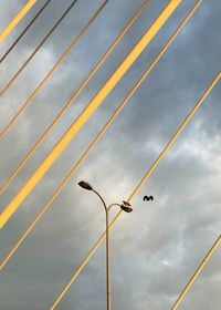 Low angle view of street lights against sky