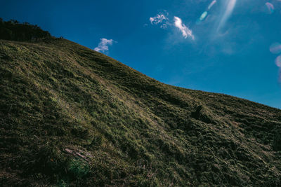 Low angle view of land and mountain against sky