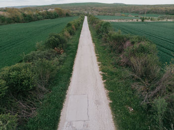 Empty road along countryside landscape