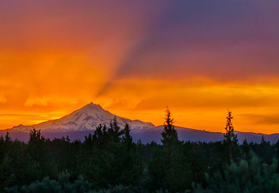 Scenic view of mountains against orange sky