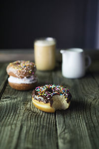 Close-up of donuts and drinks on wooden table
