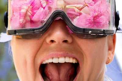 Woman wearing protective googles filled up with flowers