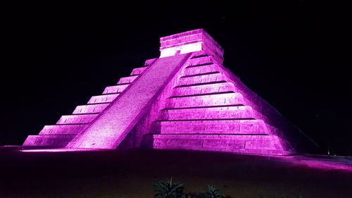 Low angle view of illuminated lamp against sky at night