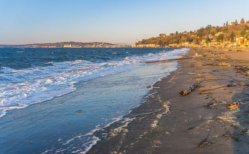 A view of alki beach in west seattle, washington on a windy day.