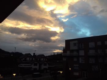 Low angle view of buildings against sky at dusk