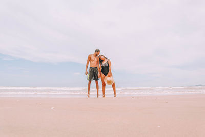 Rear view of a couple on beach