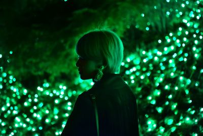 Portrait of man looking at illuminated light