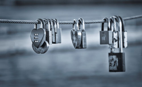 Close-up of padlocks hanging on railing