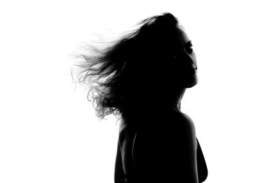 Portrait of woman with tangled hair against white background