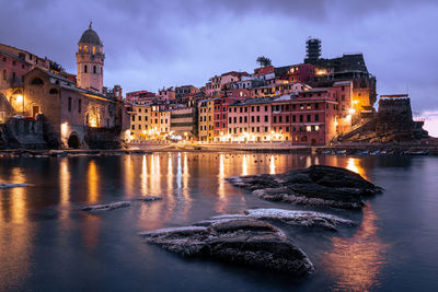 Bridge over river in city at night