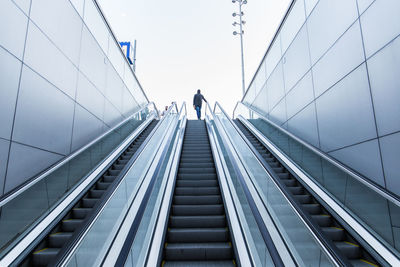 Low angle view of people on escalator