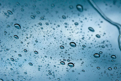Full frame shot of raindrops on glass