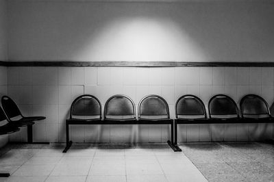 Empty chairs against wall