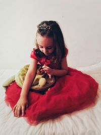 Girl sitting on bed at home