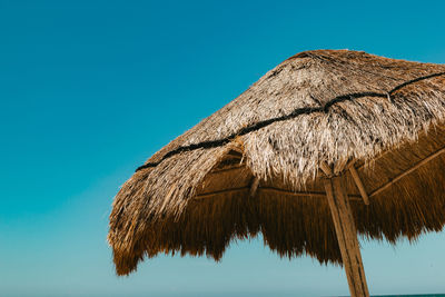 Low angle view of roof against clear blue sky