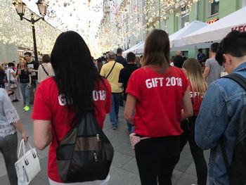 Rear view of people on street in city