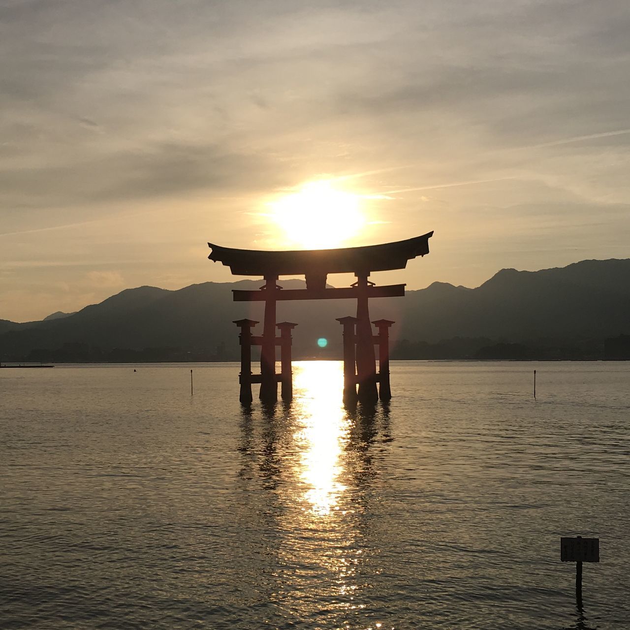 water, sunset, sky, nature, silhouette, sea, beauty in nature, idyllic, cloud - sky, tranquility, scenics, architecture, no people, built structure, tranquil scene, mountain, outdoors, beach, day