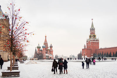 Moscow kremlin with spassky tower and saint basil's cathedral in center city on red 