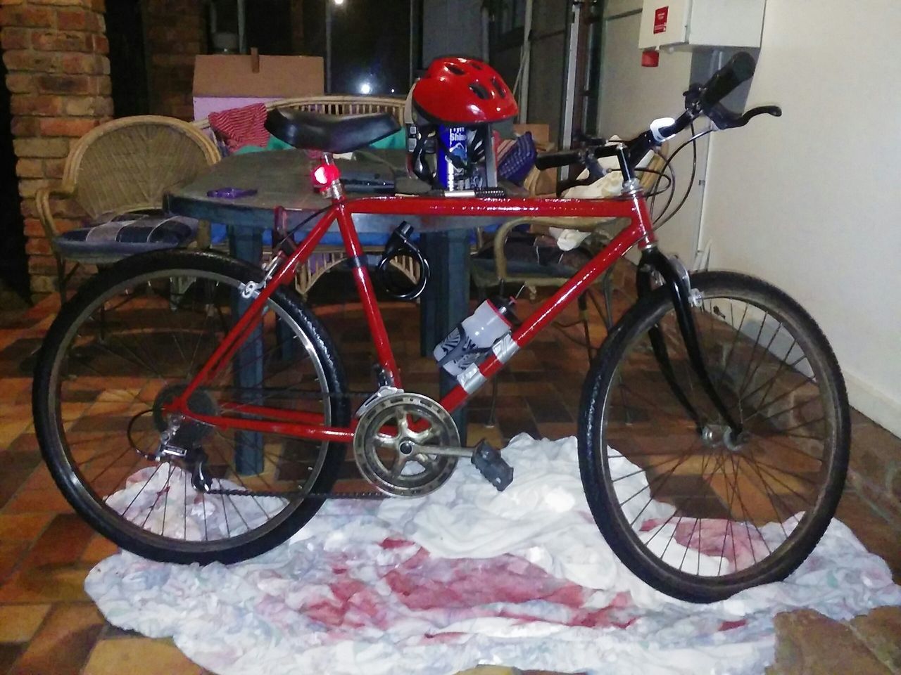 bicycle, transportation, mode of transport, stationary, land vehicle, parking, parked, indoors, wheel, wall - building feature, no people, absence, day, cycle, parking lot, wall, still life, leaning, red