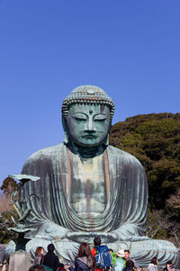 Statue of buddha against blue sky