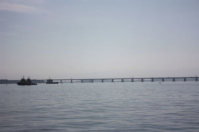 View of bridge over calm sea