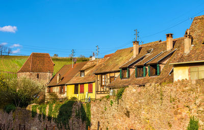 Houses and buildings against blue sky