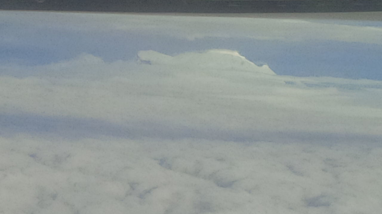 SCENIC VIEW OF CLOUDS COVERING MOUNTAIN