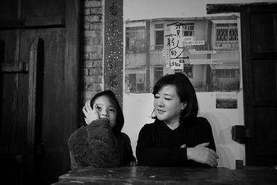 Portrait of family sitting on table