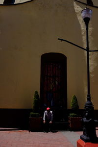 Woman standing against wall