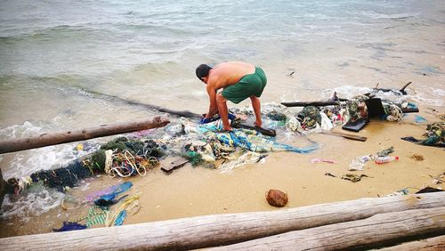 High angle view of man fishing at beach