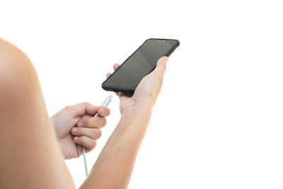 Midsection of man using smart phone against white background