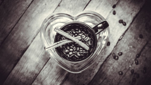 Close-up of roasted coffee beans in container on table