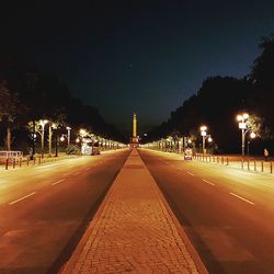 Illuminated city against clear sky at night