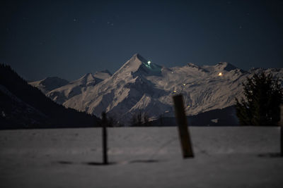 Scenic view of snowcapped mountains against sky at night