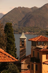 Building by mountains against sky